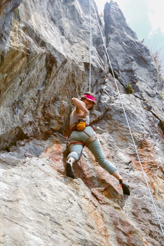 Climber on the orange rock wall